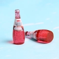 Detailed macro view of miniature red chia seed drink bottles made of resin material - Red