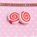Macro shot of two red and white spiral clay narutomaki slices for DIY craft and phone cases - Red