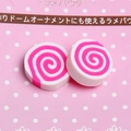 Detail view of pink and white spiral resin charms for DIY craft and phone case decor - Rose Red