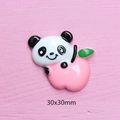 Detail of 30x30mm resin panda charm holding a pink peach for DIY phone case crafts - Pink Apple Panda