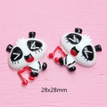 Macro detail of 28x28mm panda resin charm with musical notes for DIY phone case crafts - Panda With Red Note