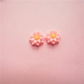 Macro shot of two pastel pink resin daisy charms with yellow centers for DIY jewelry making - Small Style / Light Pink
