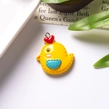 Detail view of mini resin yellow chick pendant with red heart and silver metal loop - With Eye Screw / Yolk Yellow Chick With Blue Pocket