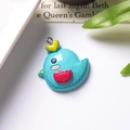 Detail shot of a blue resin cartoon bird pendant with a silver metal hook on a white desk - With Eye Screw / Light Blue Chick With Red Pocket