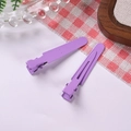 Close-up of lavender purple metal duckbill hair clips for DIY handmade crafts and styling - Purple