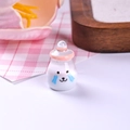 Macro detail of miniature resin yogurt bottle with cute bear face and pink cap - Pink