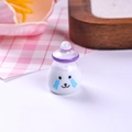 Macro detail of a miniature resin cartoon yogurt bottle with purple cap for dollhouses - Purple