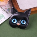 Detailed close-up of a black cat charm with blue resin eyes and a pink heart nose - Sapphire Gem Eyes