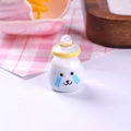 Close-up of a cute miniature resin yogurt bottle with a crying face for dollhouse DIY - Yellow
