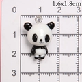 Macro detail of mini resin panda pendant with metal ring on a metric grid scale - Small Standing Panda
