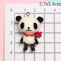 Detailed macro view showing the panda resin pendant dimensions of 2.7x3.4cm on a scale - Red Scarf Panda
