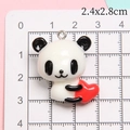 Detail shot of a cute 3D resin panda pendant holding a red heart, size 2.4x2.8cm - Heart Panda