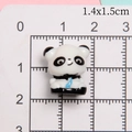 Macro scale shot showing 1.4x1.5cm dimensions of the 3D resin panda miniature charm - Sitting Panda