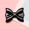 Close-up of black resin bow patch with high gloss finish for DIY hairpins and cases - 2.1x2.8cm / Black