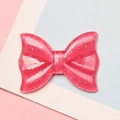 Macro detail of a sparkling pink resin bow charm with silver glitter for DIY crafts - 2.1x2.8cm / Rose Red Glitter