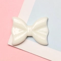 Detailed macro view of a glossy white resin bow accessory for DIY craft hair clips - 2.1x2.8cm / White