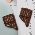 Macro detail of chocolate resin charms with MILK engraving for DIY phone case crafts - Coffee Small Style