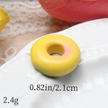 Detail shot of a yellow resin donut charm showing 2.1cm size and 2.4g weight specifications - Solid Light Yellow