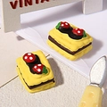 Macro view of realistic resin strawberry chocolate cookies for DIY phone case crafts - Yellow
