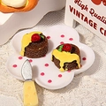 Detailed macro view of miniature resin chocolate heart cakes with a tiny palette knife - Brown Base Yellow Cream Style