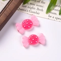 Macro detail of two pink resin candy charms with white polka dots for DIY jewelry making - Pink and Rose Red