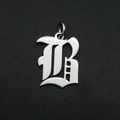Detailed macro view of Gothic letter B pendant made of polished silver stainless steel - Letter B