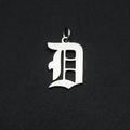 Detailed view of Old English Gothic letter D pendant in polished silver stainless steel - Letter D
