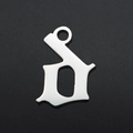 Macro shot of silver gothic letter D pendant made of durable stainless steel for DIY jewelry - Letter D