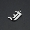 Detailed macro view of Gothic style letter J pendant in silver polished stainless steel - Letter I