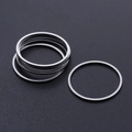 Macro detail of minimalist silver stainless steel thin rings on a black matte background - Round Style (T938) / Silver