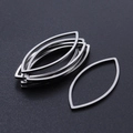 Close-up of silver-tone marquise eye-shaped hollow stainless steel jewelry charms for DIY - Marquise Style (T939) / Silver