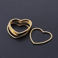 Close-up of golden stainless steel heart frames for DIY jewelry making accessories - Heart Style (T940) / Gold