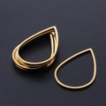Macro view of golden teardrop stainless steel pendant frames for DIY jewelry making - Water Drop Style (T941) / Gold