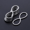 Macro shot of silver infinity shaped stainless steel charms for DIY jewelry making - Infinity Style (T942) / Silver