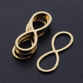 Detailed view of infinity symbol gold plated stainless steel jewelry connectors in stack - Infinity Style (T942) / Gold