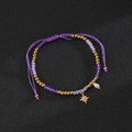 Detail of beaded bracelet with purple crystals, star charm and white pearl accent - Eight-Pointed Star