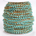 Golden stainless steel chain with turquoise enamel sun charms on a white spool roll - Ball Chain / 1 Meter/Pack / Turquoise Gold Color