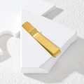 Minimalist gold tie clip with brushed metal texture on a geometric display stand - Gold