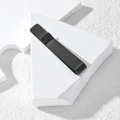 Macro view of minimalist matte black stainless steel tie clip on a white stone base - Black