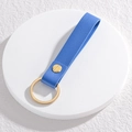 Royal blue leather keychain lanyard with lychee pattern and golden ring on white podium - Dark Blue