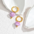 Close-up of gold hoop earrings with purple shell pendants on a textured white surface - Light Purple (OLBE952-zi)