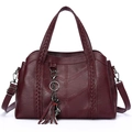 Burgundy women's handbag with litchi texture, braided handles, and a cute cat tassel charm - Red