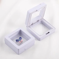 Detail view of purple PE film floating frame jewelry boxes with a push button mechanism - 1 Piece / White