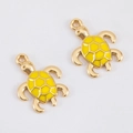 Detailed view of turtle-shaped charms in gold finish with yellow enamel for DIY jewelry - Sea Turtle (15.4x20)