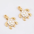 Detail of sea turtle charm with gold metal frame and white enamel for DIY jewelry - Sea Turtle