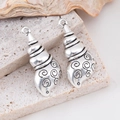 Silver conch shell pendants for DIY jewelry making on natural stone background - Spiral Conch
