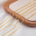 Five parallel rows of polished gold-plated copper cable chains on a beige velvet tray - Gold Flat Oval 2 / 1 Meter/Pack
