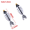 Golden fish bone charms with black and white enamel, measuring 40mm by 11.5mm size - 40X11.5mm / Black