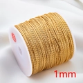 Close-up of 1mm gold twisted cord on white spool for DIY jewelry making and crafts - 1mm-KC Gold