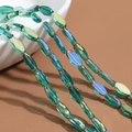 Faceted oval crystal beads in dark green AB coating for DIY jewelry making - 60 Pieces/Pack / Transparent - Green